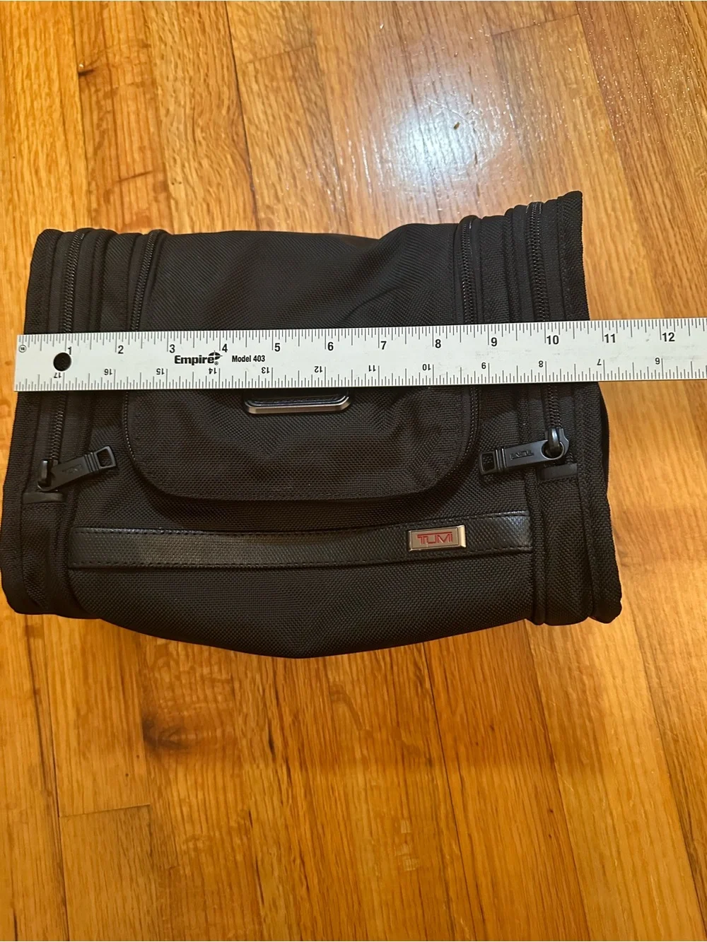 Tumi hanging travel kit with hook for hanging.